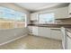 This kitchen features white cabinets, a window above the sink, and tile floors at 6125 Morningdale Ave, Lakeland, FL 33813
