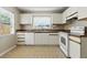 This kitchen features white cabinets, a window above the sink, and tile floors at 6125 Morningdale Ave, Lakeland, FL 33813