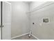 This laundry room features a storage shelf and a tile floor at 6125 Morningdale Ave, Lakeland, FL 33813