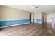 Open living space with hardwood floors and an adjacent view of the entryway at 6125 Morningdale Ave, Lakeland, FL 33813