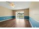 Bright living room features hardwood floors, sliding glass doors to the patio, and a ceiling fan at 6125 Morningdale Ave, Lakeland, FL 33813