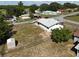 Property features a spacious backyard, white exterior, storage shed, and mature trees at 17 Oak Loop, Ocala, FL 34472