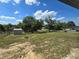 Expansive backyard with lush trees and storage shed, ready for outdoor activities at 17 Oak Loop, Ocala, FL 34472