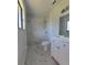 Modern bathroom featuring tiled walk-in shower, stylish vanity, and marble floors at 17 Oak Loop, Ocala, FL 34472