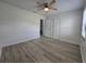 Bright bedroom with a ceiling fan, wood-look floors, and a closet at 17 Oak Loop, Ocala, FL 34472