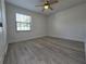 Bright bedroom with a ceiling fan and wood-look floors at 17 Oak Loop, Ocala, FL 34472