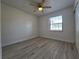 Bright bedroom with a ceiling fan and wood-look floors at 17 Oak Loop, Ocala, FL 34472