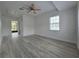 Spacious bedroom featuring wood-look floors, bright white walls, and a ceiling fan at 17 Oak Loop, Ocala, FL 34472