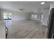 Bright and spacious living area with modern flooring and slider door to outdoor patio at 17 Oak Loop, Ocala, FL 34472