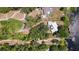 Aerial view of a home with mature trees, surrounded by greenery, and close to the water at 2292 Se 170Th Avenue Rd, Silver Springs, FL 34488