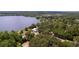 Aerial shot showcasing lakefront property with a charming home nestled among mature trees at 2292 Se 170Th Avenue Rd, Silver Springs, FL 34488