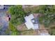 Aerial view showcasing a home nestled beside a serene lake and surrounded by lush greenery at 2292 Se 170Th Avenue Rd, Silver Springs, FL 34488