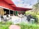 Outdoor patio with tile flooring, seating, a grill, and views of the surrounding landscape at 2292 Se 170Th Avenue Rd, Silver Springs, FL 34488