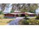Inviting single-story home featuring a lush front yard and a driveway leading to an attached garage at 2292 Se 170Th Avenue Rd, Silver Springs, FL 34488