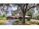 Charming single-story home with beautiful landscaping and mature trees draped with Spanish moss at 2292 Se 170Th Avenue Rd, Silver Springs, FL 34488