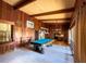 Game room with a pool table, wood paneling, beamed ceilings and open kitchen, perfect for entertaining at 2292 Se 170Th Avenue Rd, Silver Springs, FL 34488
