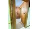 Hallway with wooden walls, closet, and door offers functionality at 2292 Se 170Th Avenue Rd, Silver Springs, FL 34488