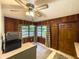 Eat-in kitchen area with wood paneled walls and view of the yard at 2292 Se 170Th Avenue Rd, Silver Springs, FL 34488