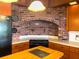 A well-equipped kitchen with a black cooktop in the center, light countertops, and brick accents at 2292 Se 170Th Avenue Rd, Silver Springs, FL 34488