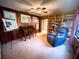 Living space offers wood paneling, a ceiling fan, and comfortable seating, ideal for relaxation and unwinding at 2292 Se 170Th Avenue Rd, Silver Springs, FL 34488