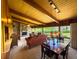 Cozy living room boasts a stone fireplace, beamed ceilings, ample seating, and bright natural light at 2292 Se 170Th Avenue Rd, Silver Springs, FL 34488