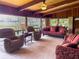 Large living room with a beamed ceiling, ample seating, and multiple windows with water views at 2292 Se 170Th Avenue Rd, Silver Springs, FL 34488