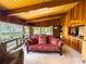 Inviting living area features beamed ceilings, wood paneled walls, and water views at 2292 Se 170Th Avenue Rd, Silver Springs, FL 34488