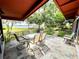 Outdoor patio area featuring a table with seating and beautiful views of the surrounding landscape and lake at 2292 Se 170Th Avenue Rd, Silver Springs, FL 34488