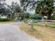 Property entrance with mature trees, outbuilding, and lush landscaping plus a mailbox at 2292 Se 170Th Avenue Rd, Silver Springs, FL 34488