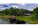 Picturesque waterfront view featuring a private dock on a tranquil lake surrounded by lush vegetation at 2292 Se 170Th Avenue Rd, Silver Springs, FL 34488