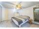 Cozy bedroom featuring soft carpet, ceiling fan, dresser, and an ensuite bathroom for added convenience at 97 Parson Dr, Winter Haven, FL 33884