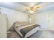 Comfortable bedroom with soft carpet, a ceiling fan, dresser, and a soothing ambiance at 97 Parson Dr, Winter Haven, FL 33884
