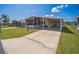 Exterior view showcasing a well-maintained lawn, carport, and appealing home design in a vibrant community at 97 Parson Dr, Winter Haven, FL 33884