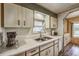 Well-lit kitchen featuring laminate countertops, stainless steel sink, and ample cabinetry at 97 Parson Dr, Winter Haven, FL 33884