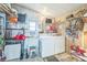 Functional laundry area with a washer, dryer, sink, shelves, and ample storage space at 97 Parson Dr, Winter Haven, FL 33884