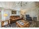 Living room featuring comfortable seating, neutral walls, ceiling fan, and warm lighting at 97 Parson Dr, Winter Haven, FL 33884