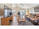 Open living space with wood-look floors, inviting sofa, television, and ample seating for relaxation at 97 Parson Dr, Winter Haven, FL 33884