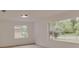 Bright living room with two windows overlooking a green outdoor space at 1255 Pine St, Altamonte Springs, FL 32701