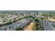 A scenic aerial view of a community nestled within a lush, green landscape with a golf course and expansive views at 1890 Flora Pass Pl, Kissimmee, FL 34747