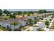 Aerial view of a modern townhome showcasing its blue exterior, attached garage, and manicured landscaping in a community setting at 1890 Flora Pass Pl, Kissimmee, FL 34747