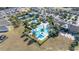 Aerial view of a community pool area surrounded by lush landscaping and palm trees at 1890 Flora Pass Pl, Kissimmee, FL 34747
