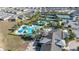 Aerial view showcases a community pool, tennis courts, and bocce ball courts at 1890 Flora Pass Pl, Kissimmee, FL 34747
