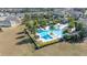 Aerial view of a resort-style community pool area with palm trees and lounge chairs at 1890 Flora Pass Pl, Kissimmee, FL 34747