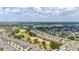 Broad aerial shot showcasing a residential area bordering a golf course, illustrating the proximity to outdoor recreation and spacious lawns at 1890 Flora Pass Pl, Kissimmee, FL 34747