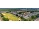 Aerial view of a community adjacent to a golf course at 1890 Flora Pass Pl, Kissimmee, FL 34747