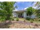 Backyard with a covered patio, manicured lawn and lush landscaping, creating a private oasis at 1890 Flora Pass Pl, Kissimmee, FL 34747