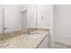 Bright bathroom with white cabinets, granite countertop, and large mirror at 1890 Flora Pass Pl, Kissimmee, FL 34747