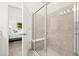 Modern bathroom featuring a glass-enclosed shower with built-in bench and neutral tiling at 1890 Flora Pass Pl, Kissimmee, FL 34747