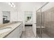 The bright bathroom features a double sink vanity and glass enclosed shower at 1890 Flora Pass Pl, Kissimmee, FL 34747