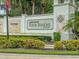 Community sign with manicured landscaping and water feature at Four Seasons at Orlando at 1890 Flora Pass Pl, Kissimmee, FL 34747